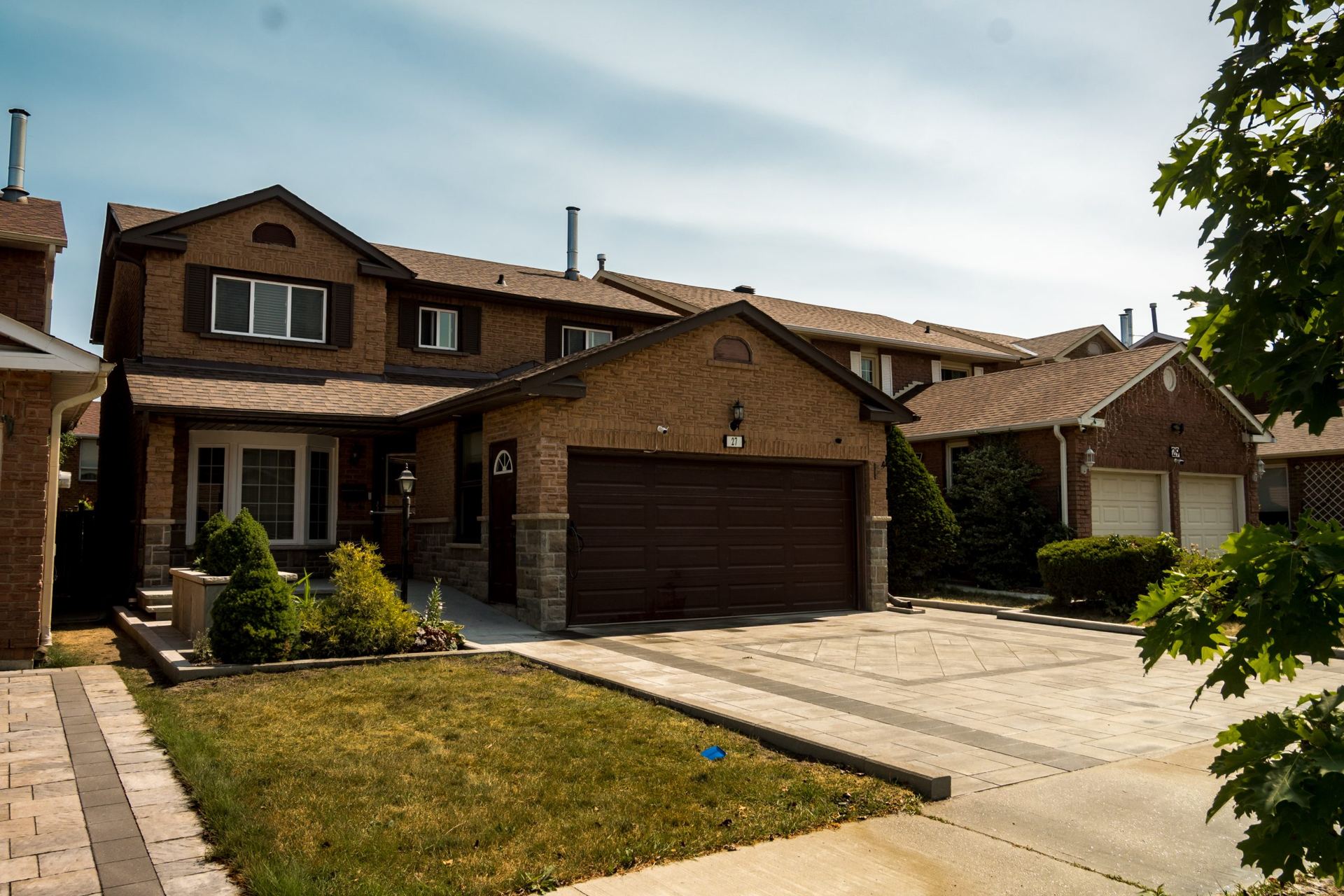 Wide driveway with a centre inlay leading to a double garage