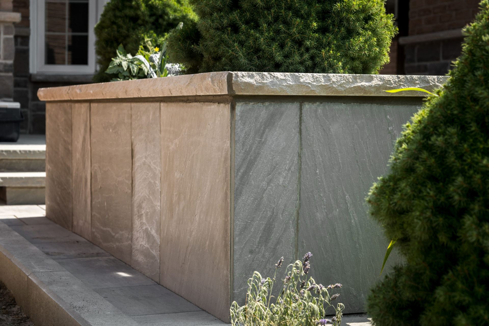 Raised planter wall and stone capping