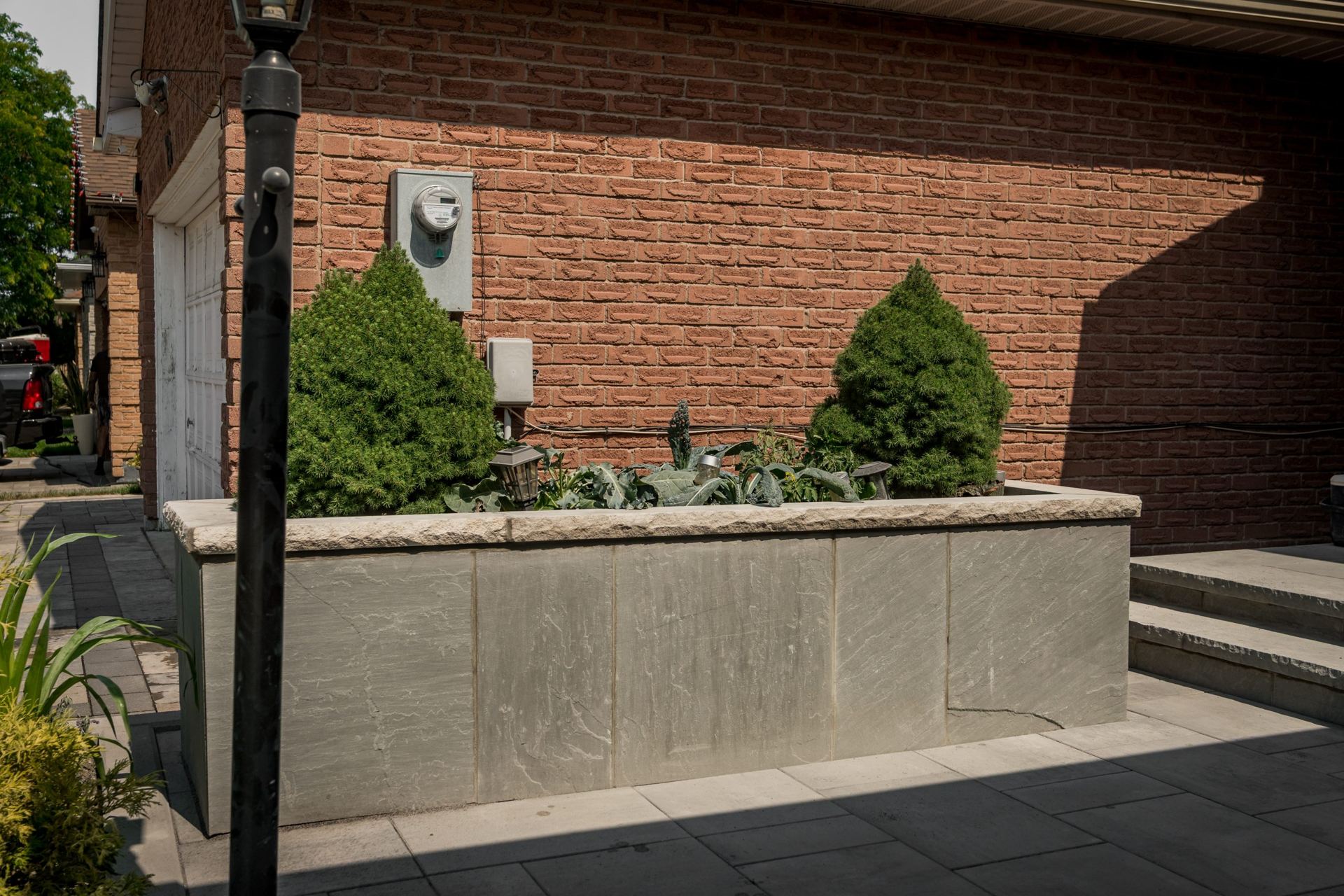 Stone planter beside a home's entrance